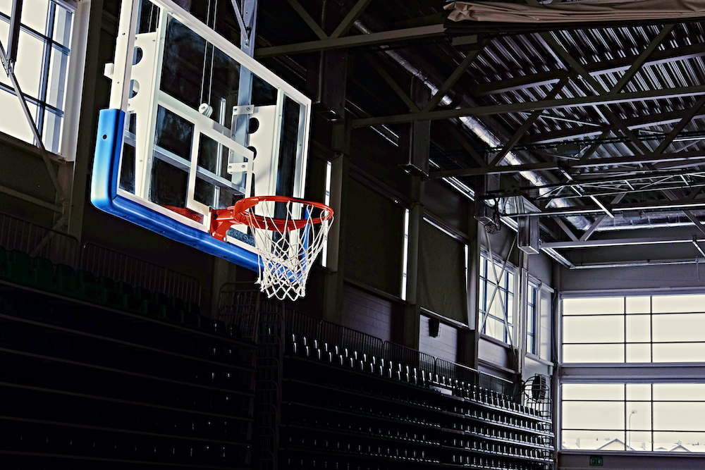 Close-up image of a basketball hoop in a game hall.
